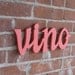 Vino painted wooden cutout.