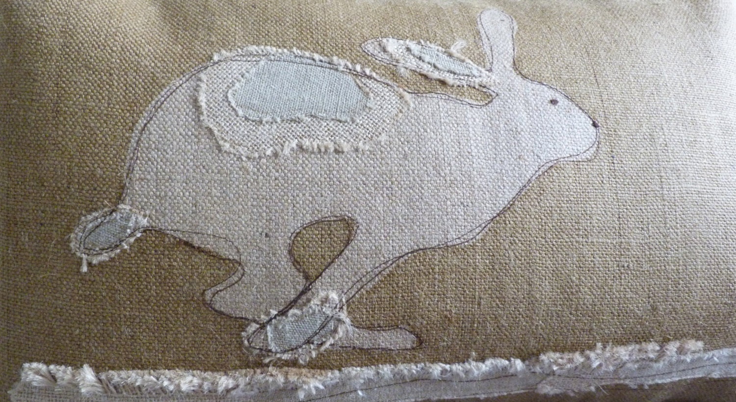 handprinted rustic hessian hare cushion cover with applique detailing
