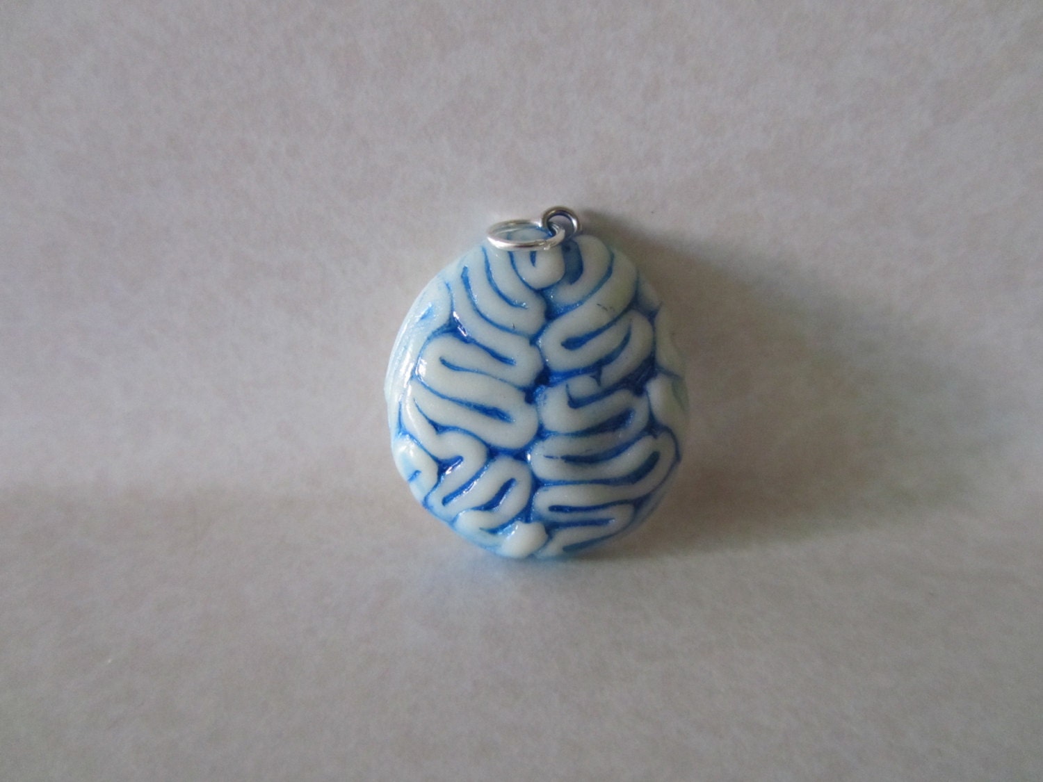 Glow in the dark brain pendant black light responsive