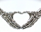 skeleton hands making an I heart you sign necklace Blue Bayer Design NYC