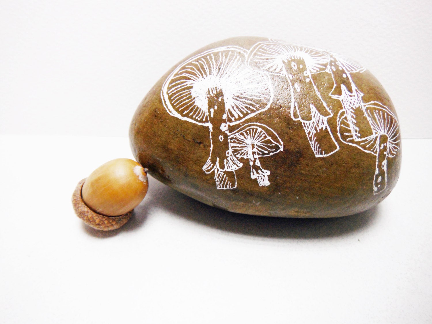 river rock painted with white mushrooms as a paperweight - FallingLadies