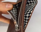 Tan leather wallet with black and white op art lining