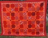 Modern Vibrant Queen size quilt in rich shades of orange, red and maroon.