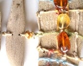 Colorful handmade necklace from driftwood and natural Baltic Sea amber
