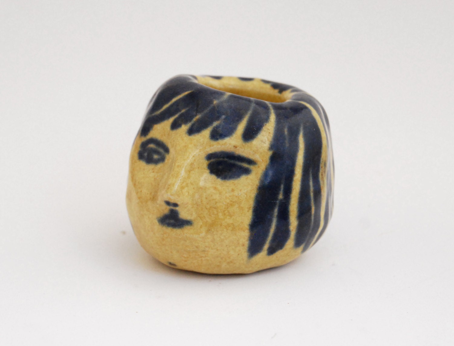Girl's head ceramic candle holder in mustard and blue