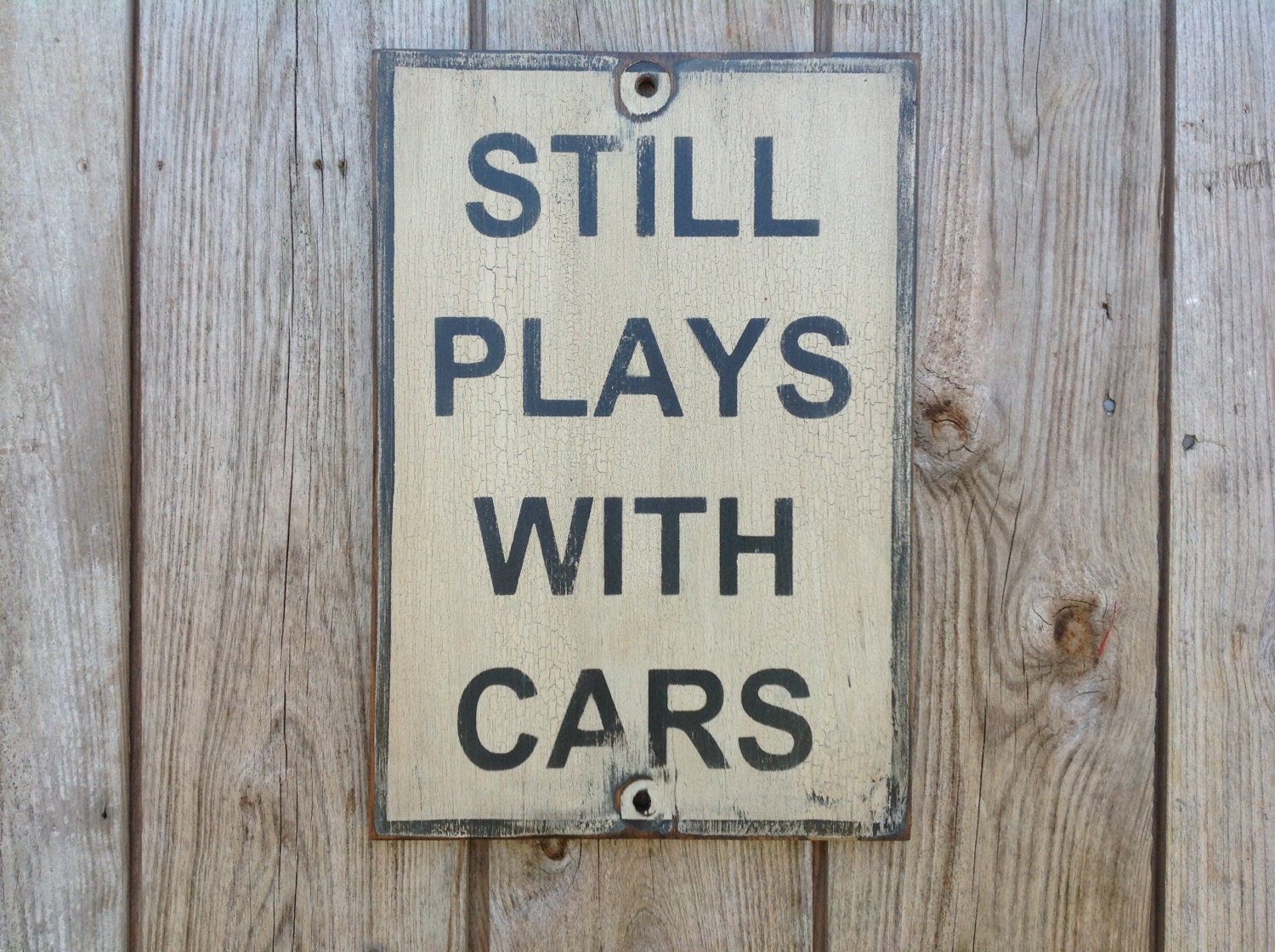 Wood sign painted still plays with cars