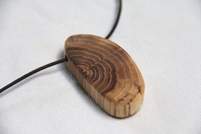 oval oak wood pendant on a leather cord