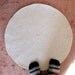 small off-white round wool rug mat