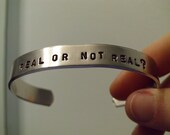 Mockingjay  -  Real Or Not Real Katniss And Peeta Hand Stamped Silver Aluminum Cuff Bracelet -  Geekery
