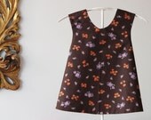 Reversible pinafore for baby girl, toddler, criss-cross apron, baby smock. Dark chocolate, floral print 100% cotton fabric. Size 2T.