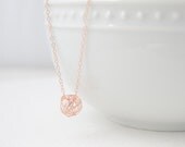 Rose gold love knot necklace on rose gold
