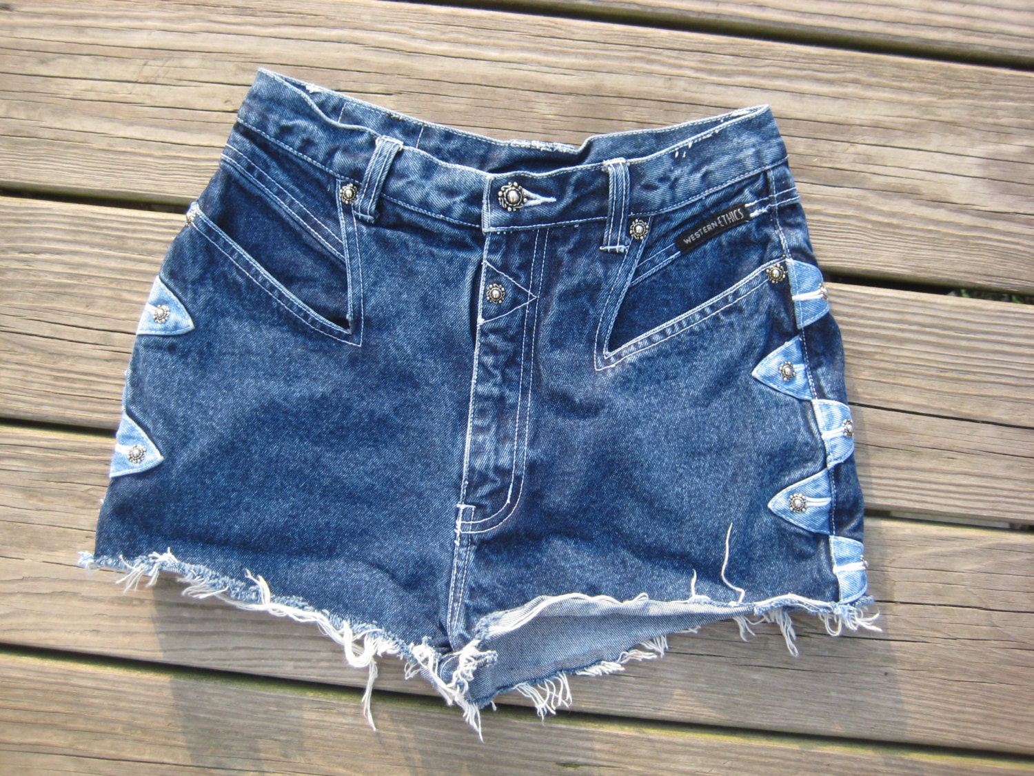 Medium wash vintage Western Ethics unique high waisted cutoffs with metal detail size 7/8