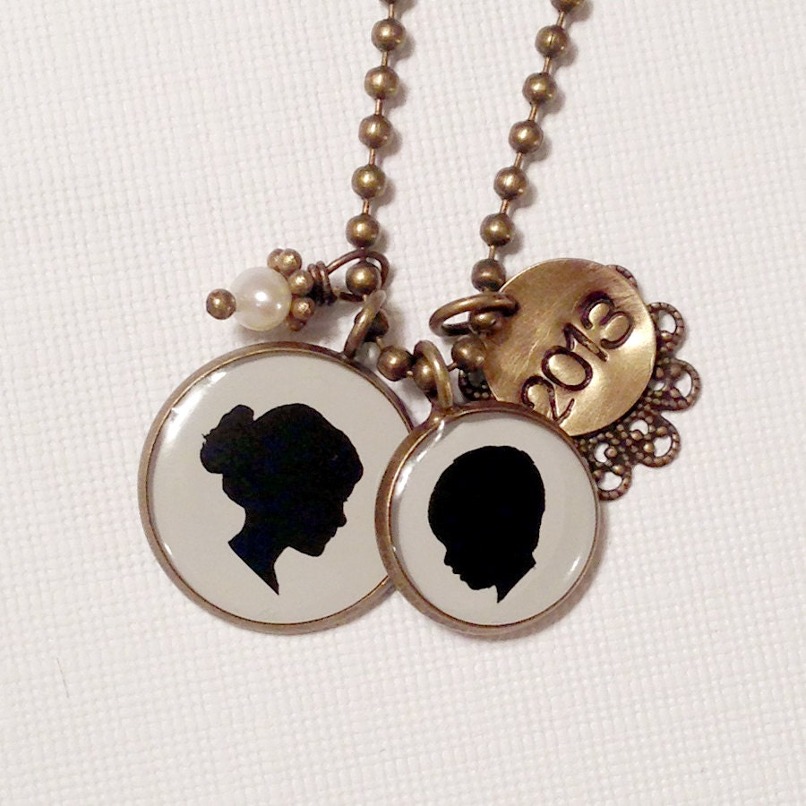 Two Child or Pet Silhouette Pendant Necklace with one large and one medium size pendant and stamped tag