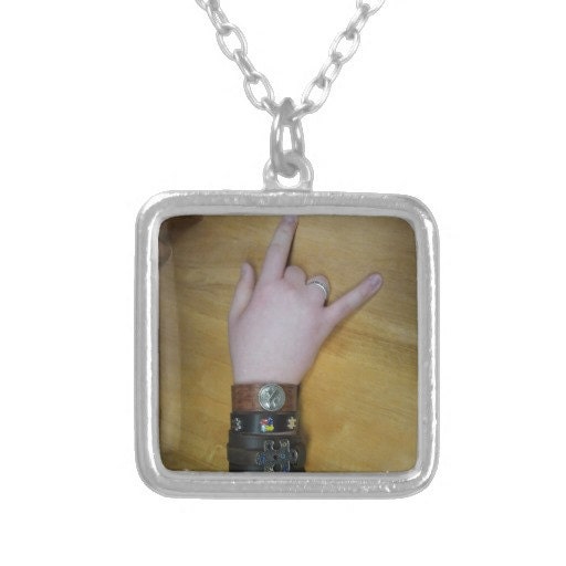 Necklace with photo and sign language "I love you" by someone with autism who made the awareness cuffs.