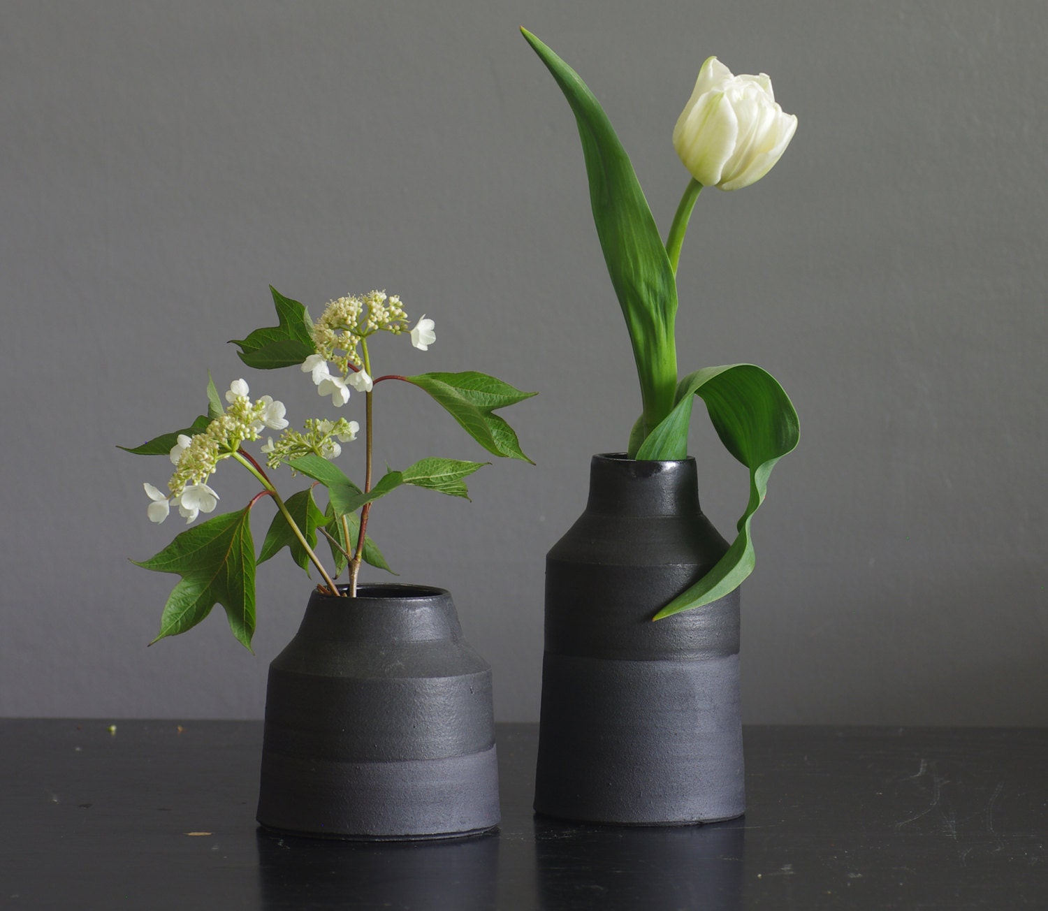 MTO matte black vase pair. matte glazed black stoneware bottles with cork stopper. pottery ceramic modern minimal simple