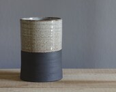 tall straight vase or utensil holder . black stoneware with white glaze. modern minimal pottery ceramic design