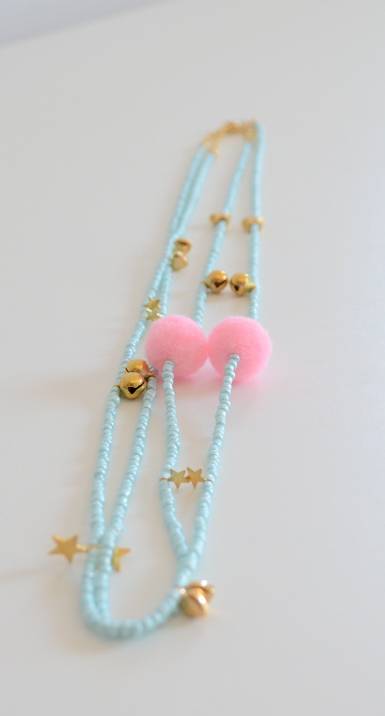 Blue charm necklace with pink pompon