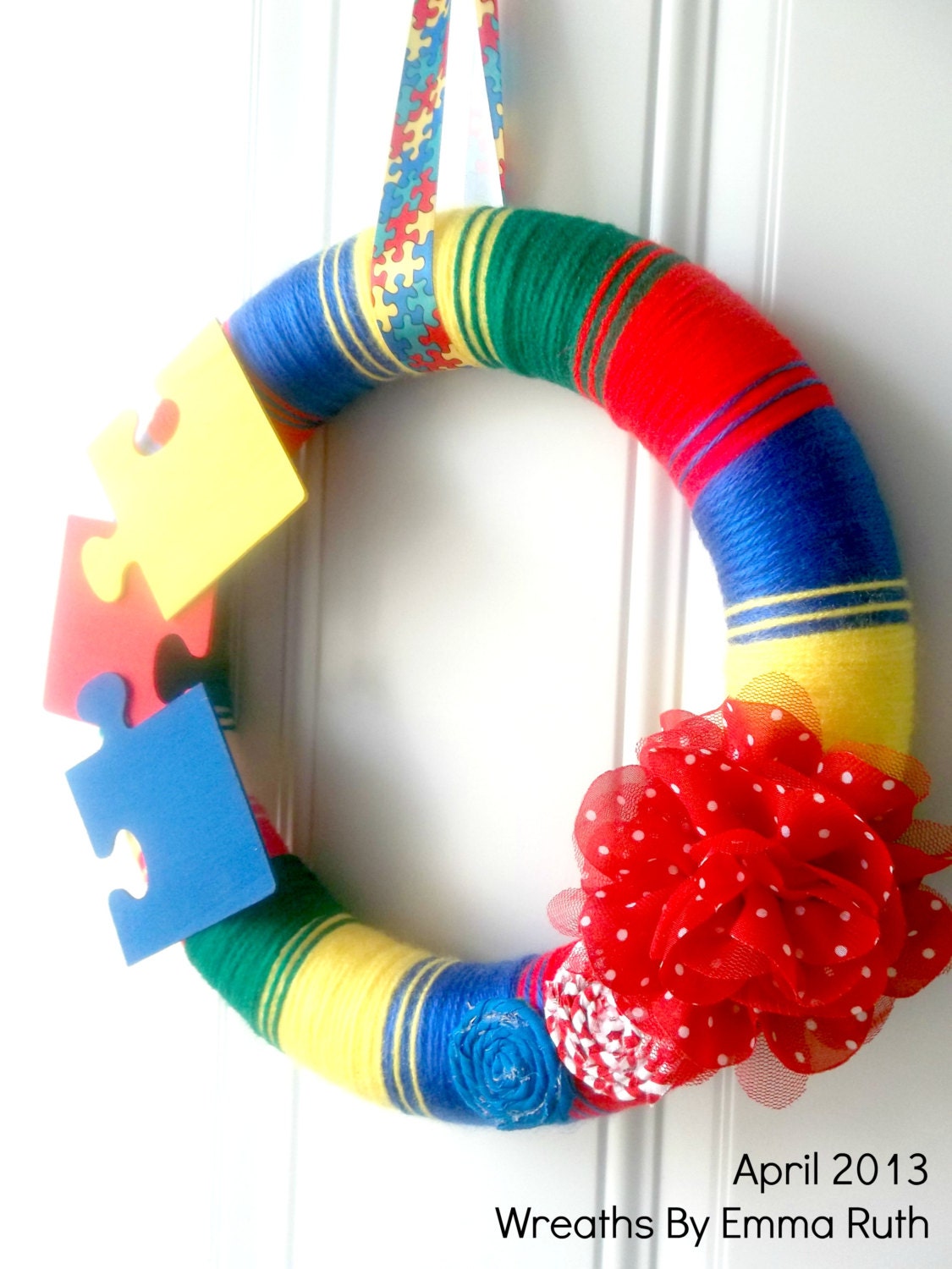 Autism Awareness Yarn Wreath with puzzle pieces red, blue, yellow, green