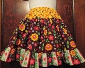 Girls size 6-6X ruffled twirlling skirt.  3 tiered elastic waist skirt.  Brown, yellow with flowers & sparkles.