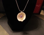 Shell with purple pearl necklace