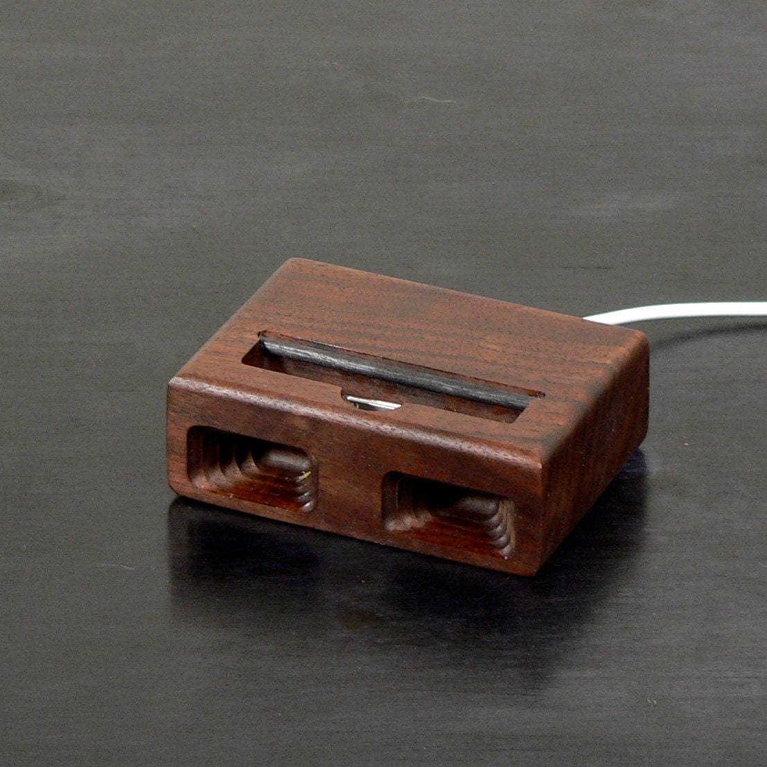 Acoustic dock  for iPhone 4 in Black Walnut - Amplifies sound through unique acoustical pockets .