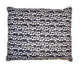 Handmade nap throw pillow in black and white music notes with black swirl back