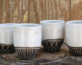 set of four slip-carved black and white tumblers