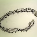 A crocheted black metal toned evening necklace