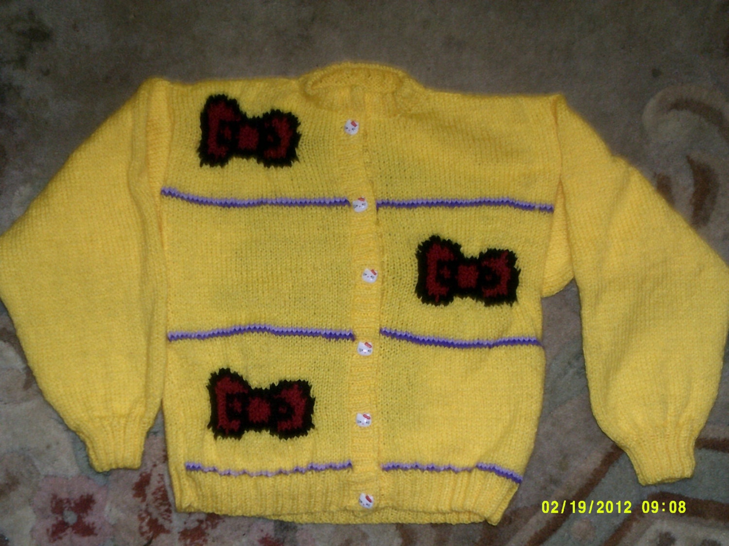 colourful, hand knitted, cardigan/jacket with hello kitty style design