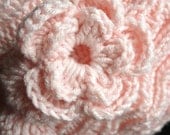 Knit hat with flower embellishment