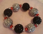 Chunky Silver, Black disco beaded stretchy bracelet with small red, clear spacer beads.