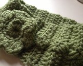 Green Crocheted headband with a green flower and a brown button.  Fits an average adult head