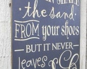 You can shake the sand from your shoes but it never leaves your soul - typography word art beach wood sign