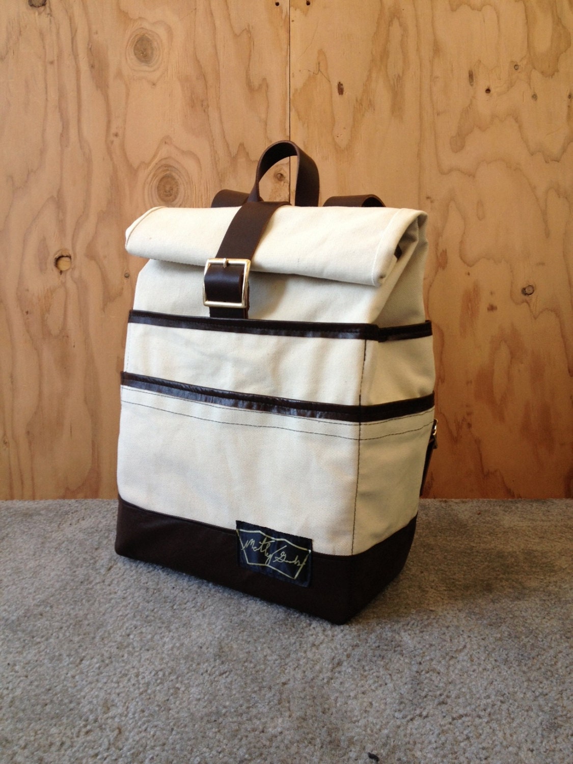 The Weekender Backpack in bull denim with leather base and optional 15" laptop sleeve