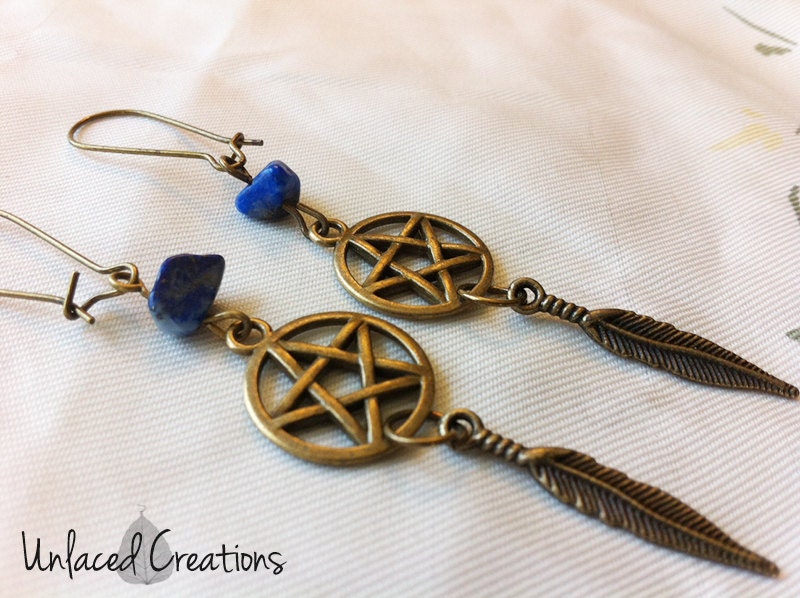 evelyn. brass pentacle, feather, and lapis lazuli earrings.