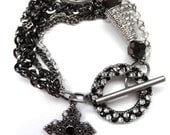 Black and white crystal bead multichain charm bracelet with cross charm