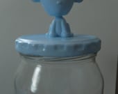 Decorative glass jar with monkey topper