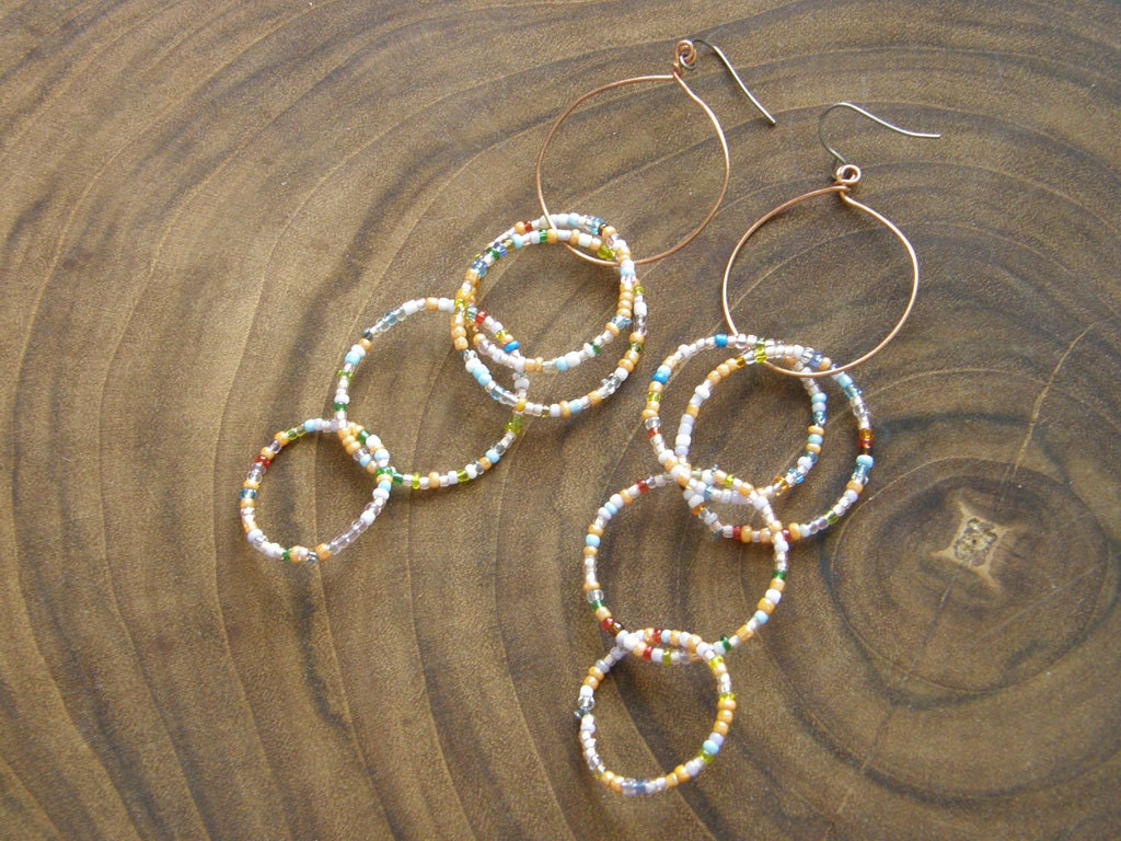 Looped Shoulder Dusters. Random Rainbow circles. Avant-garde 3-Dimensional Structural Hoops.