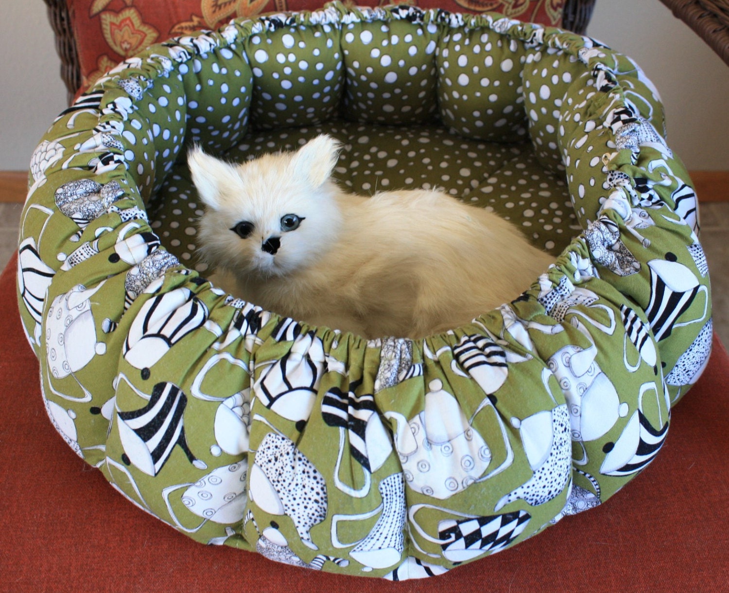 Round Cat Bed In Olive Green Covered With Tea Pots
