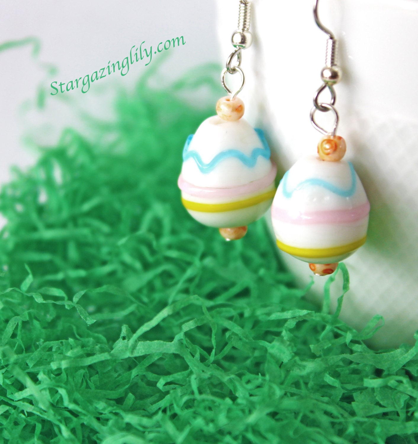 Lampwork Glass Easter Egg Earrings White with Blue Pink Yellow Orange. Dangle, hook style earrings. on Hypoallergenic surgical steel.