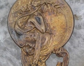 An Art Nouveau Mucha goddess stamping in vintage brass..
