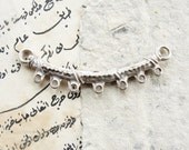 Silver colored connector or focal piece