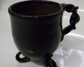 Black cup with engraved snowflake/star design