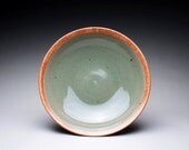 handmade pottery serving bowl with green celado and orange shino glazes