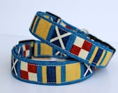 Nautical dog collar in blue, tan, and red--  "Nauti Dog" in a maritime print flags