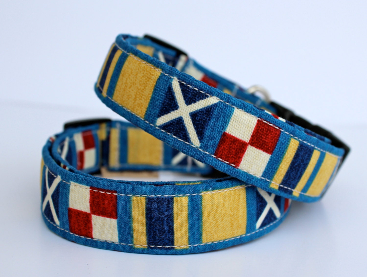 Nautical dog collar in blue, tan, and red--  "Nauti Dog" in a maritime print flags