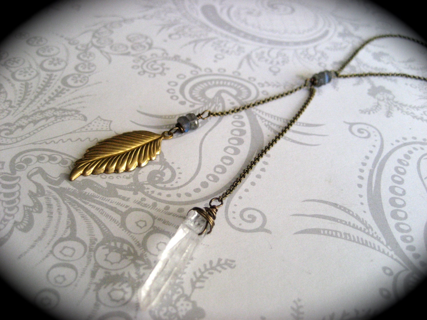 Sedona Necklace - long brass necklace with raw quartz crysta, labradorite,l and a brass feather charm