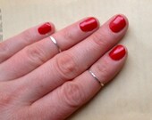 TWO Sterling silver knuckle rings, above the knuckle rings, hammered silver