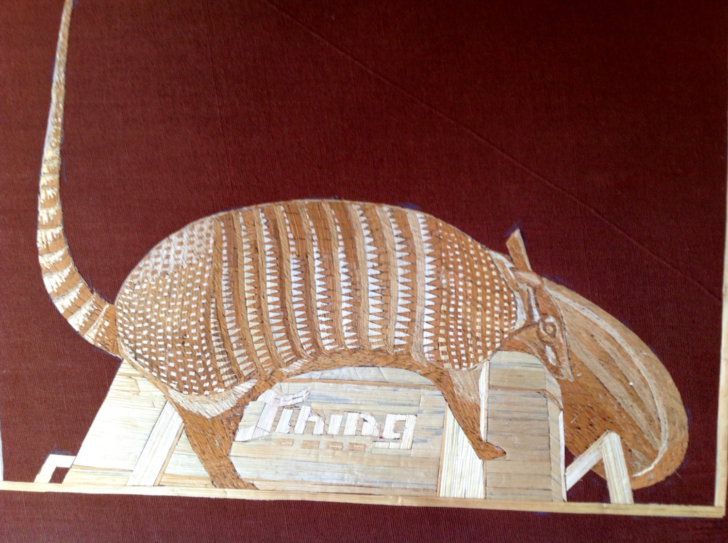 Texas Armadillo in rice straw art.  Handmade with rice straw is dried leaves of rice plant. Have U seen ancient leaf art.
