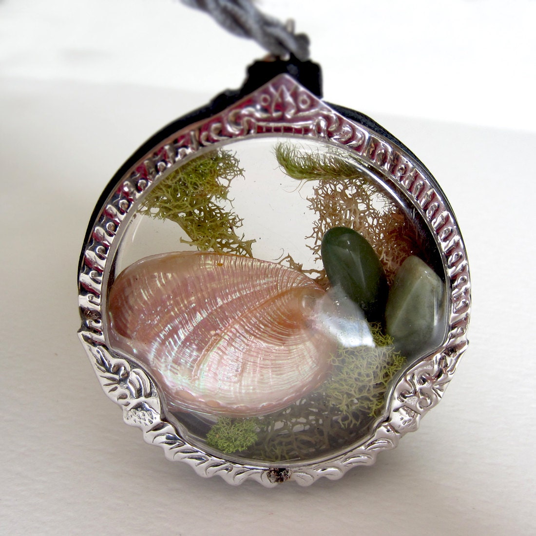 Underwater sea mini terrarium window locket. Bio dome with peach shell and semiprecious stones in green moss. Enviro statement necklace